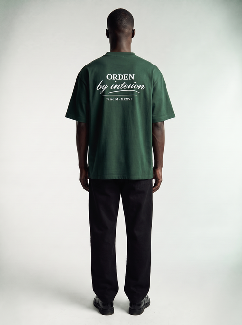 By Intention Tee in Green — back view showing the ORDEN back print